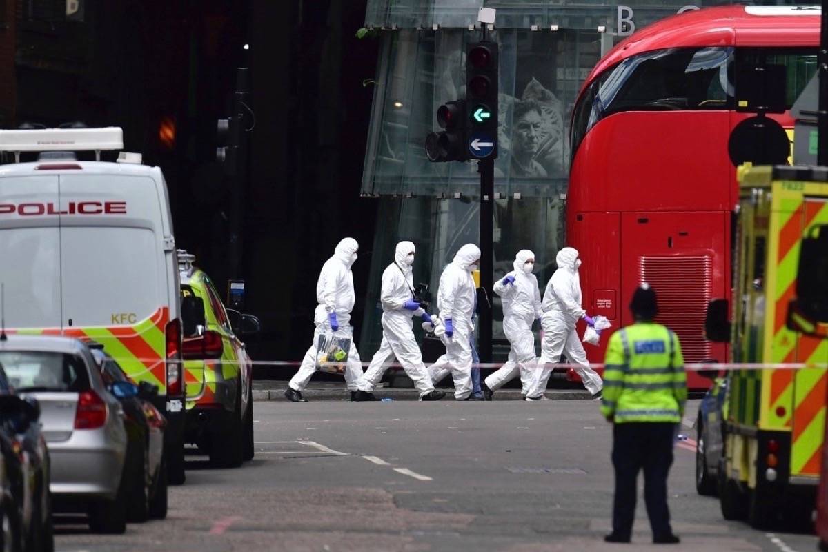Police forensic officers outside Borough Market, London, Sunday June 4, 2017, near the scene of Saturday night’s terrorist incident. Several people were killed in the incident and emergency officials said dozens were treated at London hospitals and a number of others suffered less serious injuries. (Dominic Lipinski/PA via AP)
