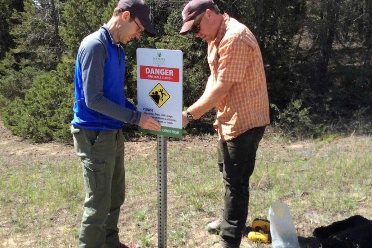 Chad Townsend (left) and Richard Klafki, NCC stewardship coordinator, install signage on the Hoodoos hike.Submitted photo