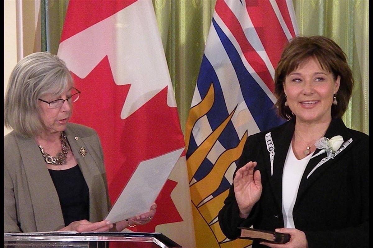 B.C. Liberal house leader Mike de Jong and Premier Christy Clark speak after MLAs took their oaths of office last week. (TOM FLETCHER/BLACK PRESS)                                Premier Christy Clark takes oath of office from Lt. Gov. Judith Guichon at ceremony for cabinet ministers in Victoria Monday (TOM FLETCHER/BLACK PRESS)