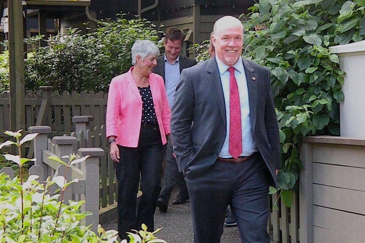 NDP leader John Horgan and Victoria MLAs Carole James and Rob Fleming visit a townhouse project with units set aside for below-market housing, built in 1996. (TOM FLETCHER/BLACK PRESS)