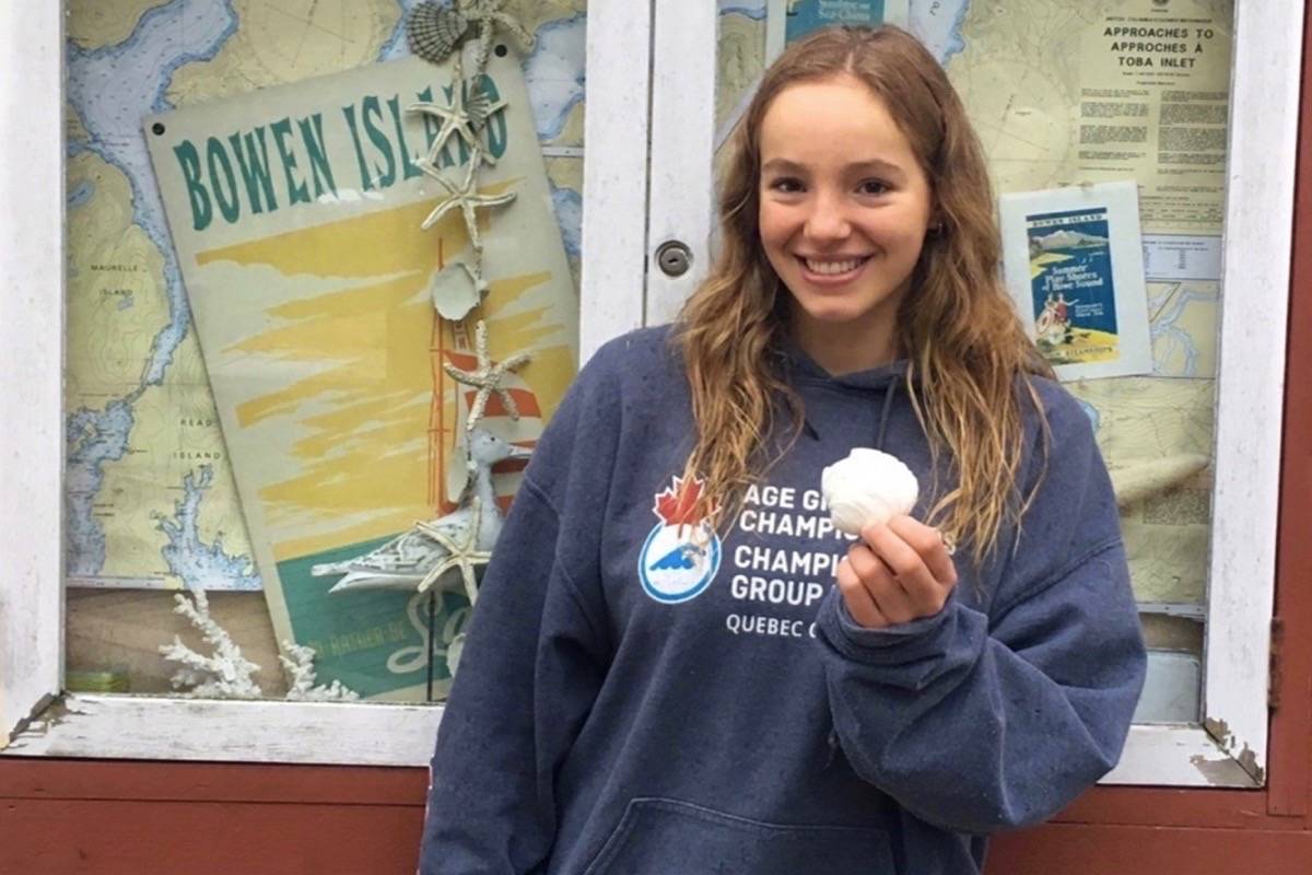Emily Epp, 17, holds a shell she found on her swim around Bowen Island, B.C. on Saturday June 17, 2017 in this photo provided by the Epp family. It took nearly 11 hours, but a 17-year-old girl from Kelowna, B.C., has completed her gruelling goal of swimming around an island off the coast of Vancouver. THE CANADIAN PRESS/Handout.