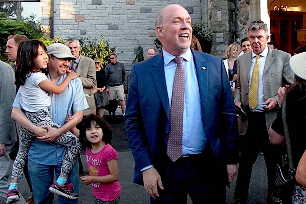 Premier-designate John Horgan greets cheering supporters outside Government House in Victoria Thursday evening, after being offered a chance to lead an NDP-Green government. (Tom Fletcher/Black Press)