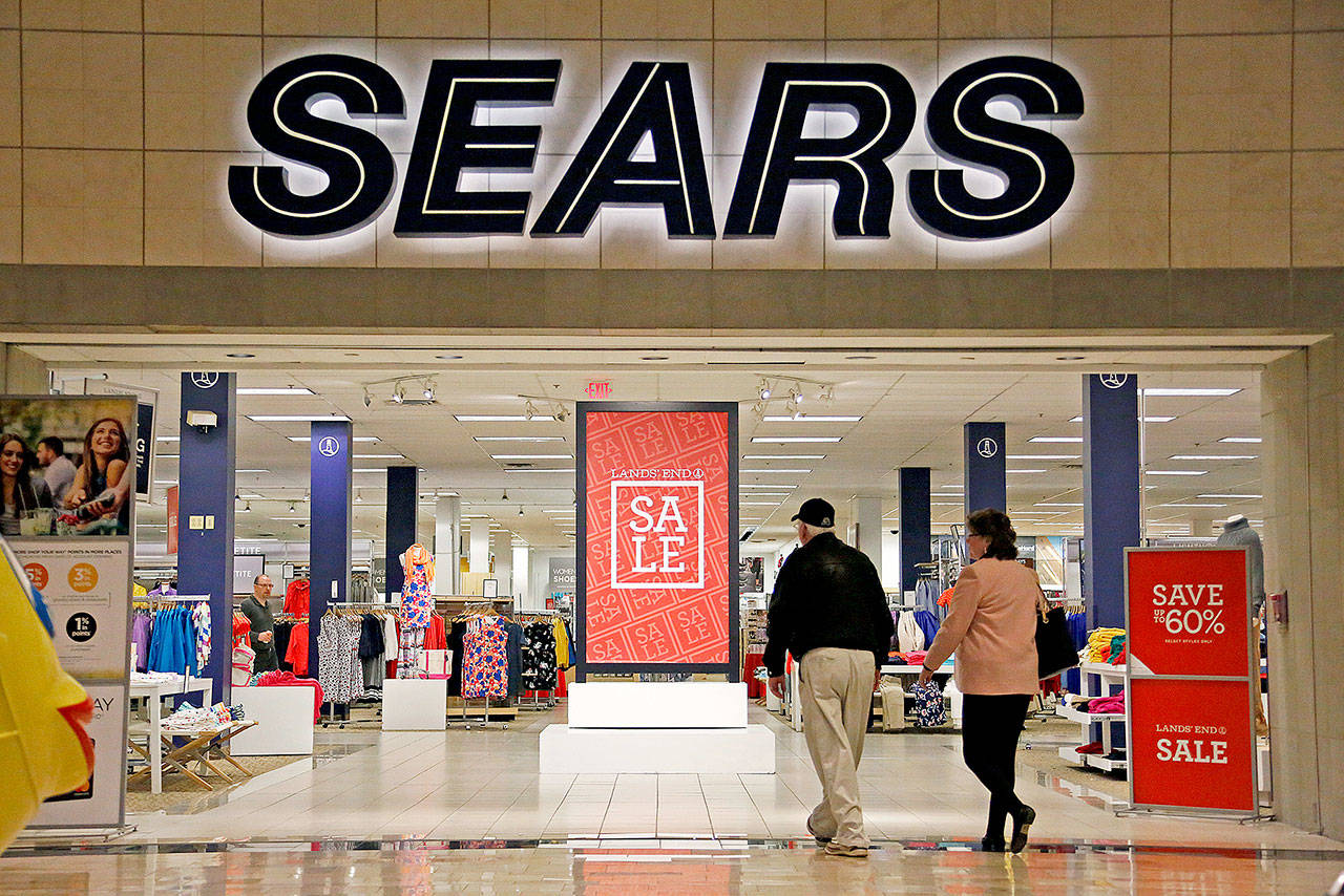 FILE - In this Wednesday, Feb. 8, 2017, file photo, shoppers walk into a Sears store in Pittsburgh. Sears said that there is “substantial doubt” that it will be able to remain in business. The company, which runs Kmart and its namesake stores, has struggled for years with weak sales. (AP Photo/Gene J. Puskar, File)