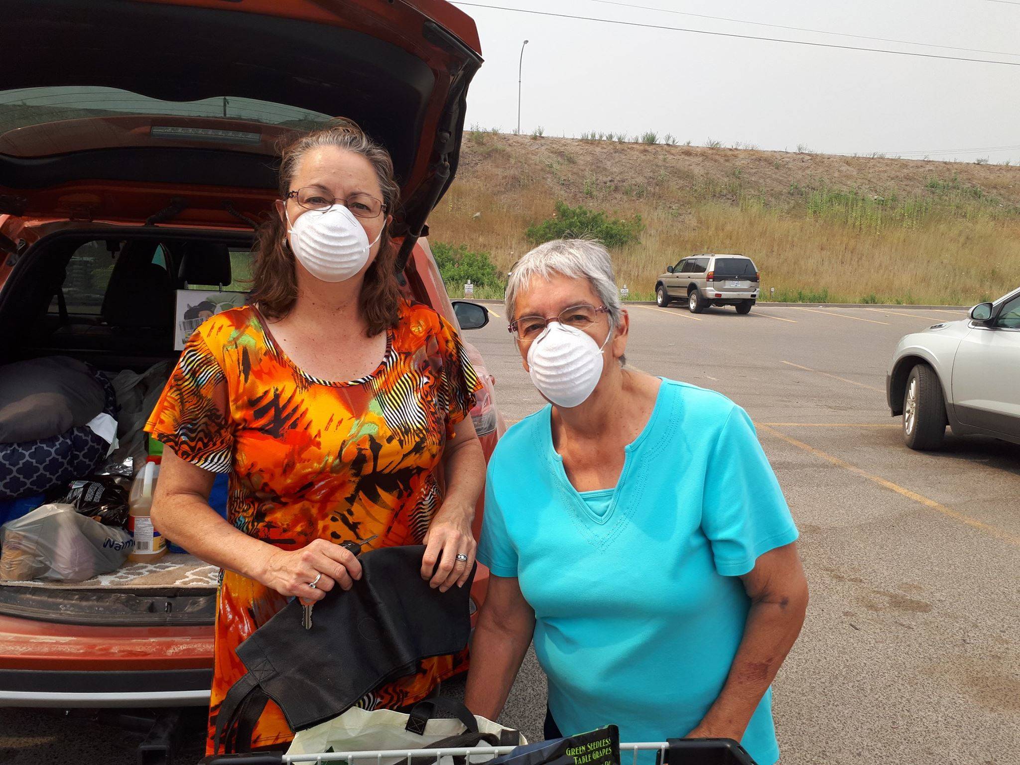 Williams Lake residents Diana Galisky and her mom Betty Rucker – who were evacuated from Spokin Lake Road Friday – were wearing masks given to them for free by Wholesale Club Sunday afternoon. “They also gave us candies for our soar throats,” Diana said. (Photo by Williams Lake reporter Monica Lamb-Yorski)