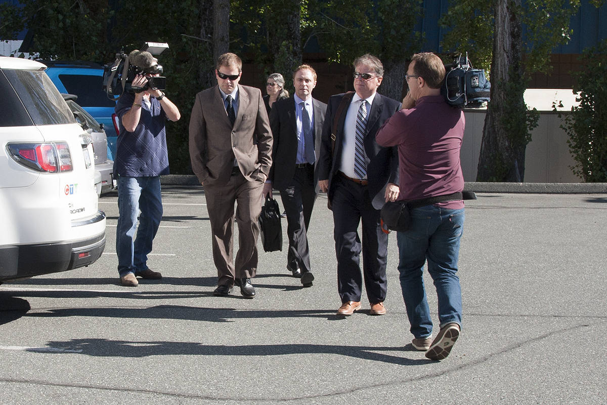 Swarmed by media, Kenneth Jacob Fenton (left) and his lawyers Chris Massey and Dale Marshall enter Western Communities Court for sentencing Friday. (Katherine Engqvist/News Gazette staff)