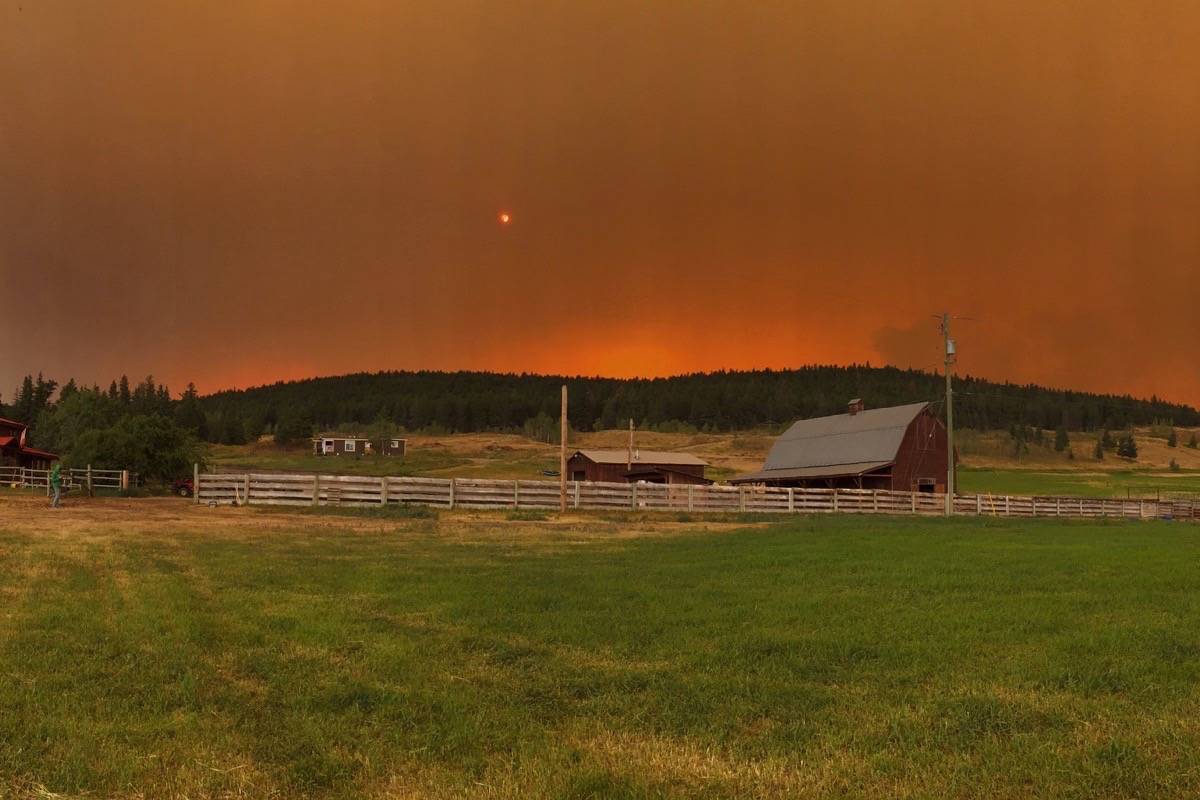 The Beacher Ranch at the corner of Highway 20 and Farwell Canyon last night. Raylene and Bryan Poffenroth’s home has been refuge for Riske Creek neighbours who have been fighting to save their homes since July 7. Crews were pulled off the fires again yesterday leaving Riske Creek residents hoping the fire won’t jump the guards they have made. (Bailey Fuller photo)