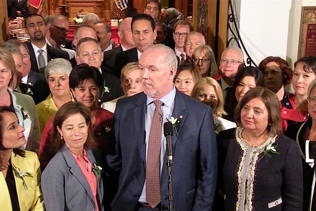 NDP leader John Horgan is surrounded by 40 elected members at they took their oaths of office as MLAs June 7. (Tom Fletcher/Black Press)