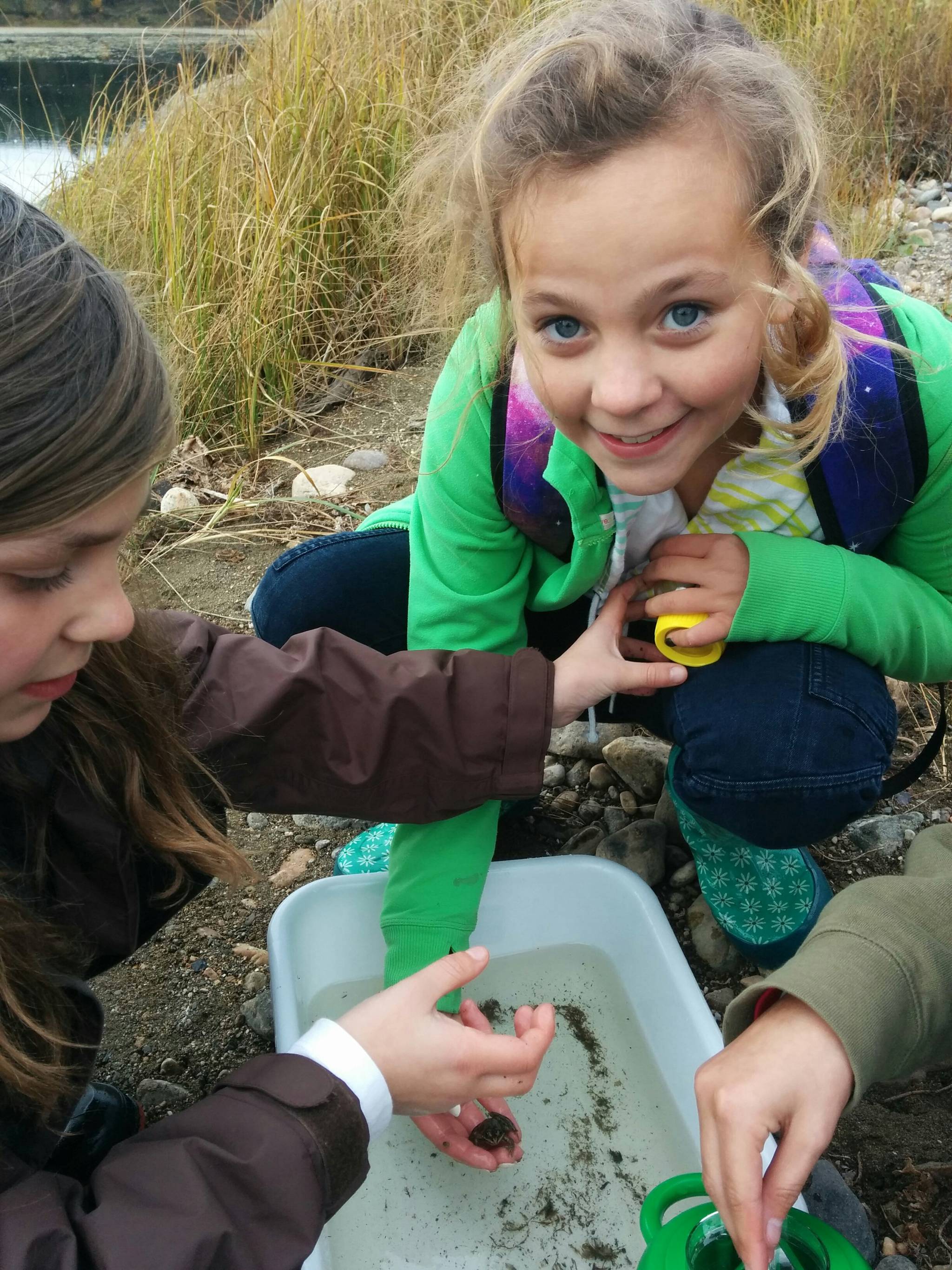 Rahne Stanbury, with Hannah Kendler beside, from Windermere Elementary School, learn about frogs, insects, and other residents of the wetlands. Submitted photo